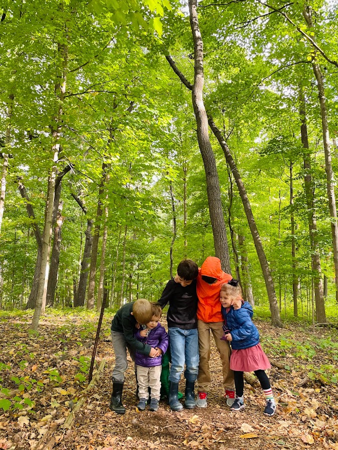 five homeschool kids in the woods
