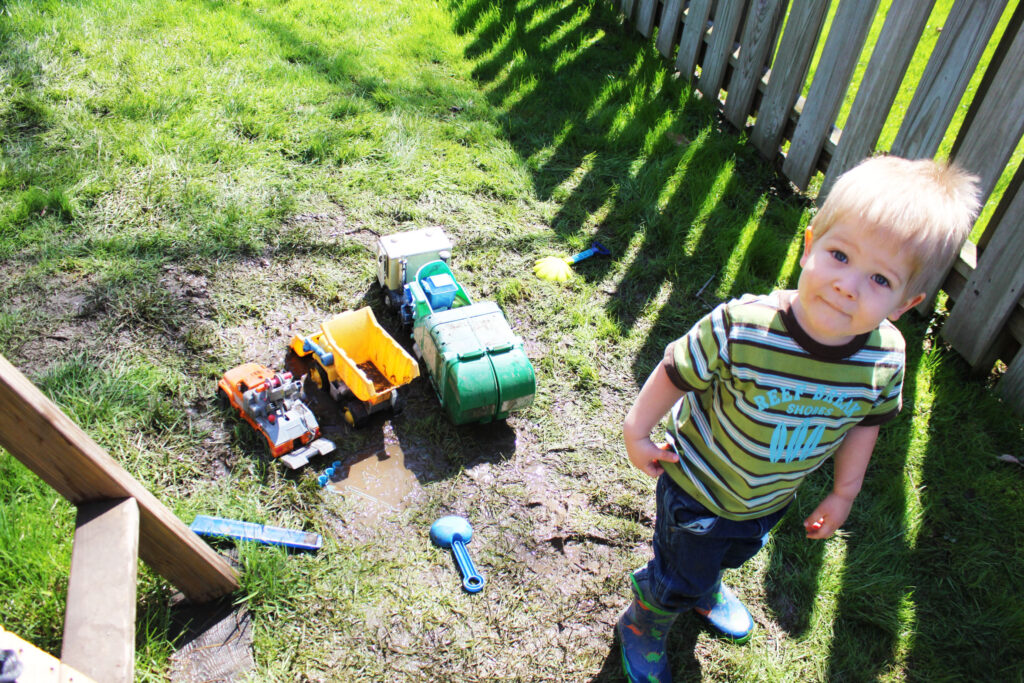 homeschool boy playing in the mud