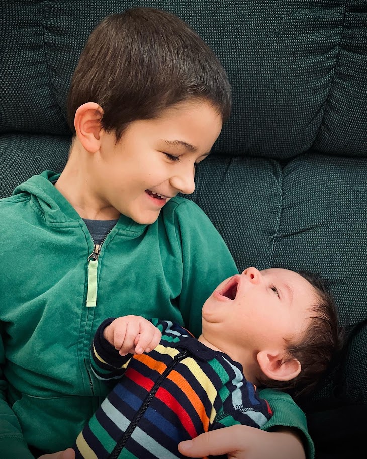 homeschool boy holding baby brother