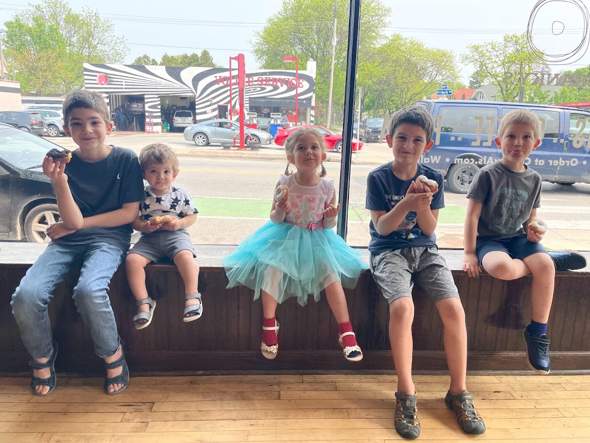 five homeschool children eating donuts