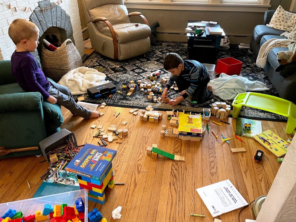 two children in living room playing with blocks