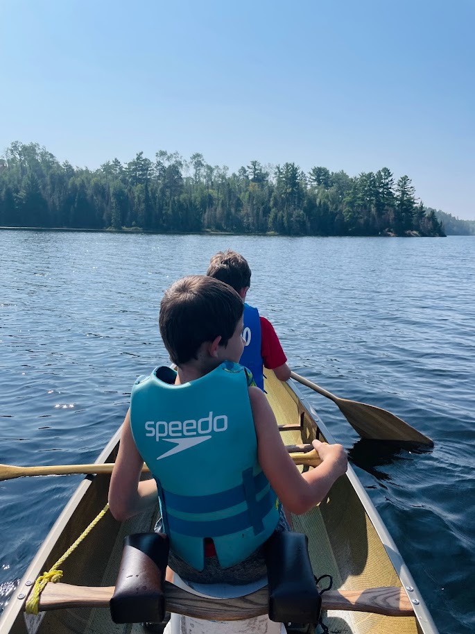 homeschool boys in a canoe on the lake