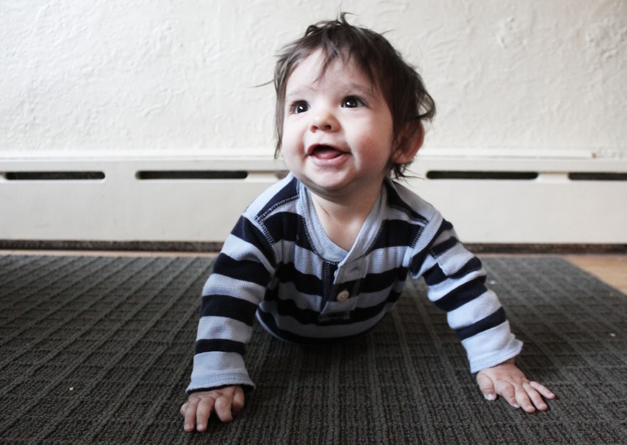 baby boy lying on the floor and smiling