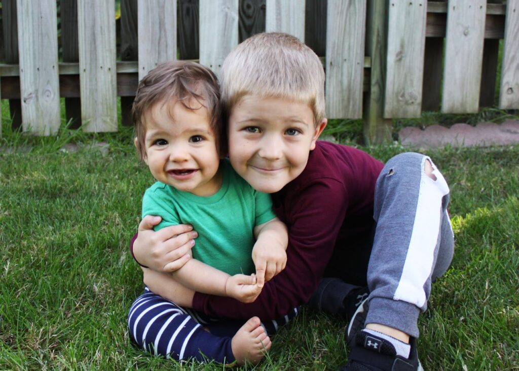 boy hugging his baby brother