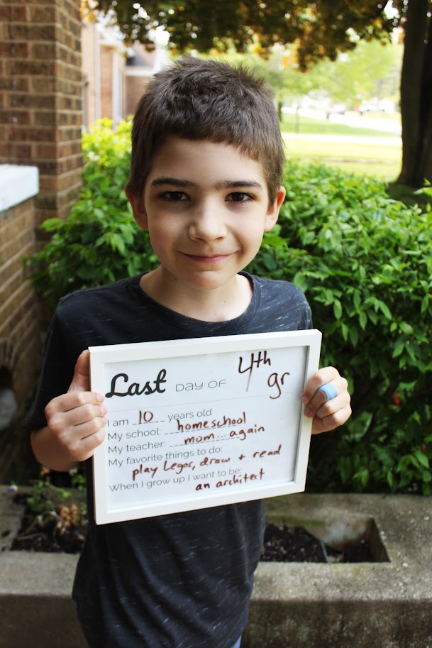 fourth grade boy holding sign