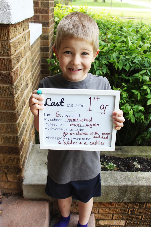 boy holding last day of homeschool sign