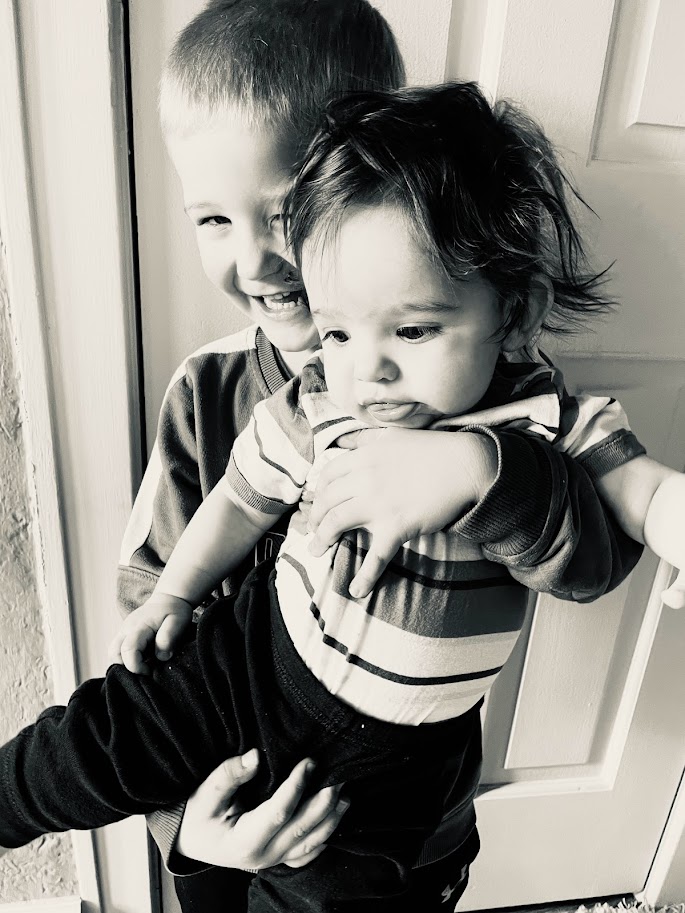 young boy holding baby brother