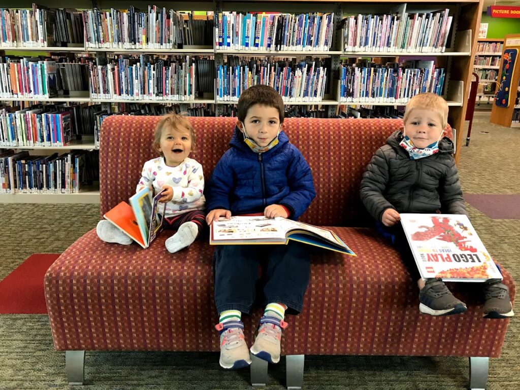 three homeschool children at the library