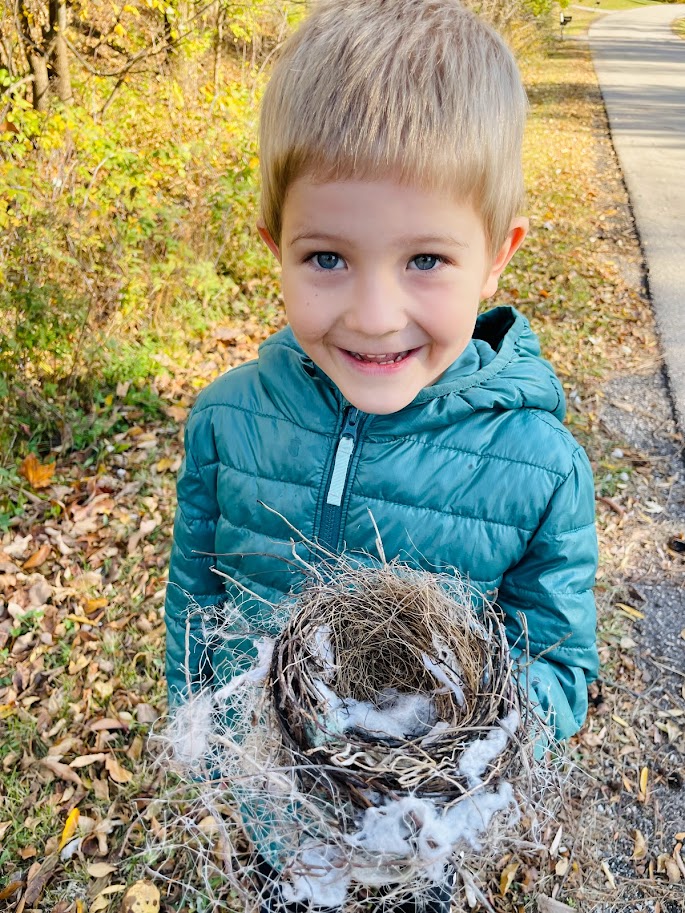 homeschool boy holding bird nest