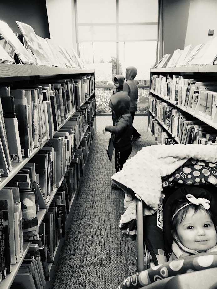 four homeschool children at the library