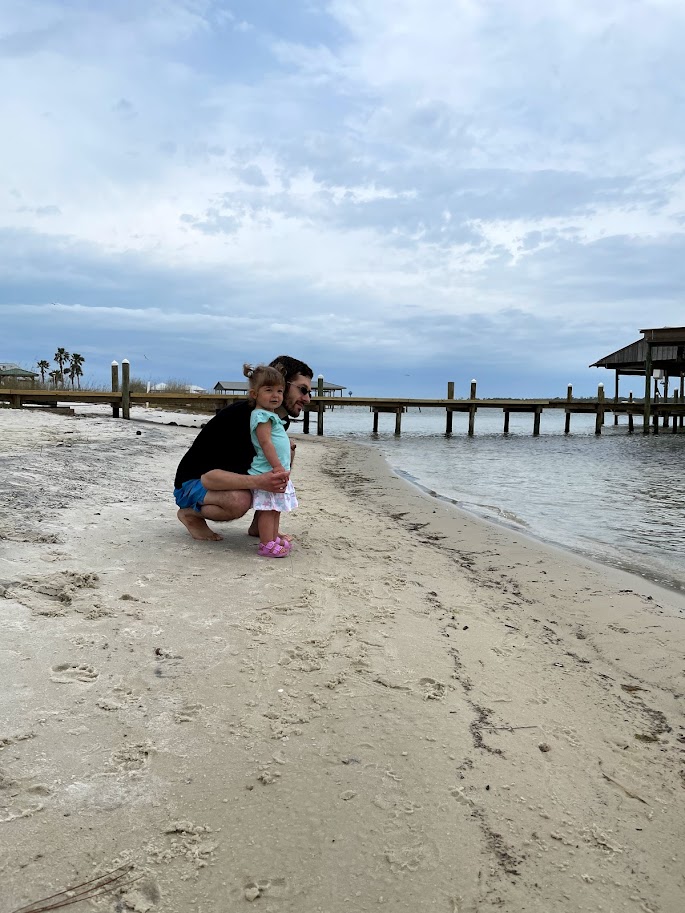 dad and toddler girl on the beach