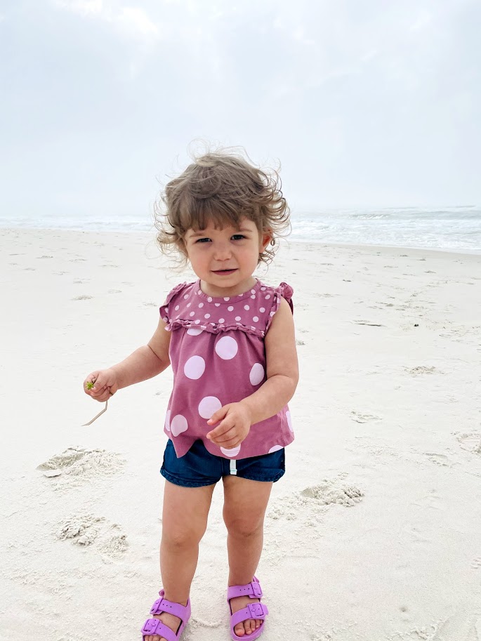 toddler girl at the beach in summer