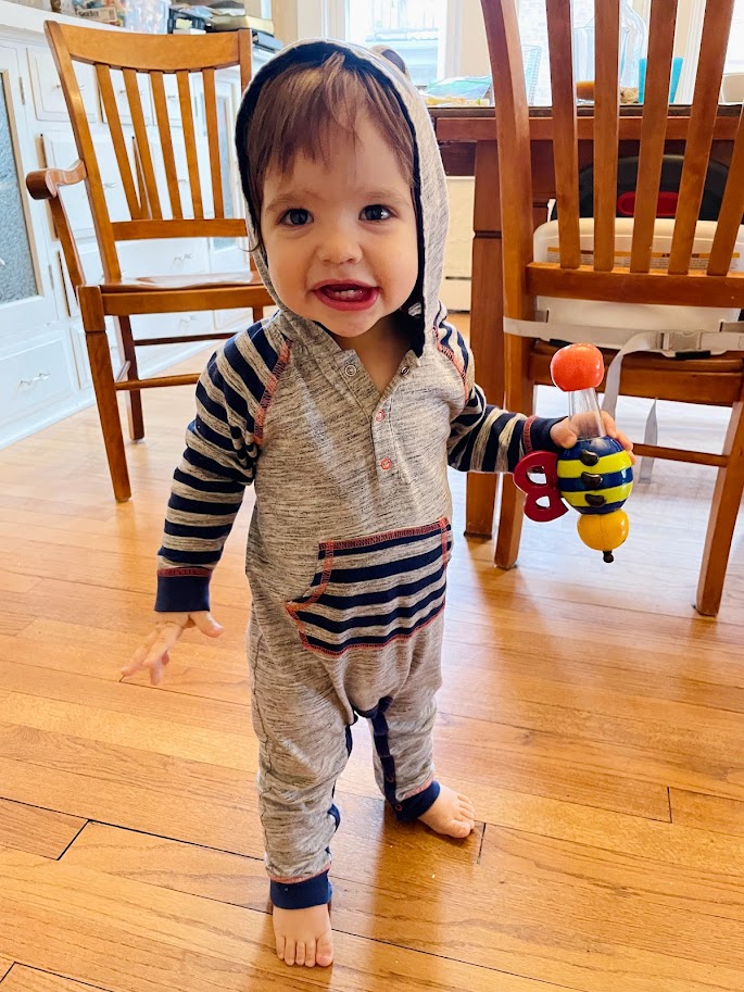 baby boy standing in dining room