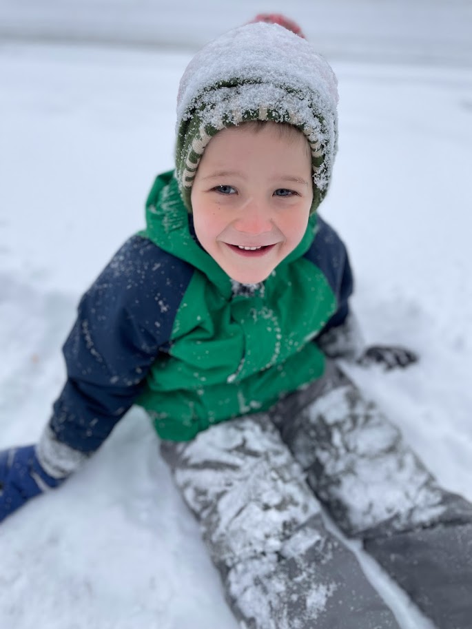 homeschool boy sitting in the snow