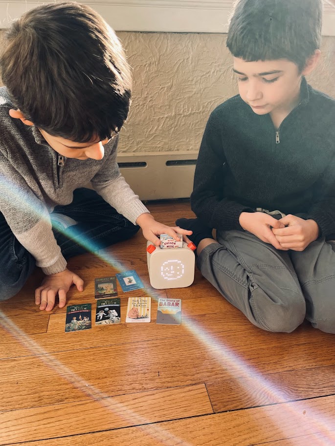 two homeschool boys listening to yoto player