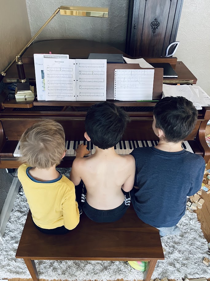 three homeschool boys practicing piano