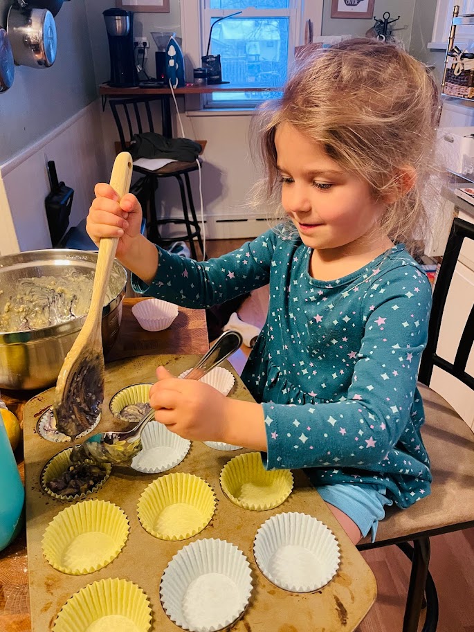 young homeschool girl making muffins in the kitchen