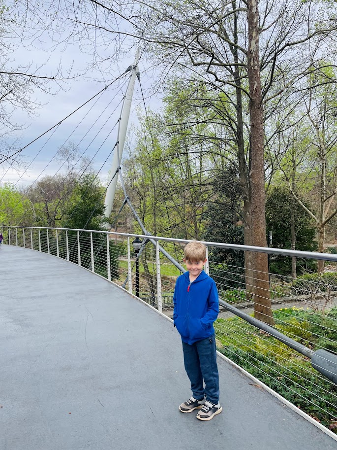 homeschool boy standing on bridge