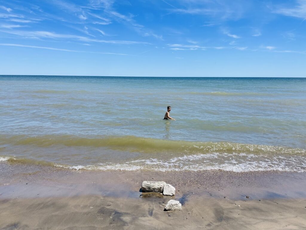 homeschool boy swimming in lake michigan