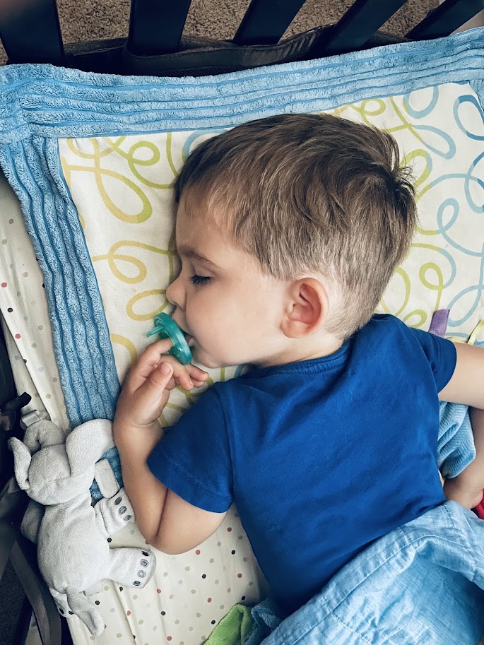 homeschool toddler boy sleeping in crib