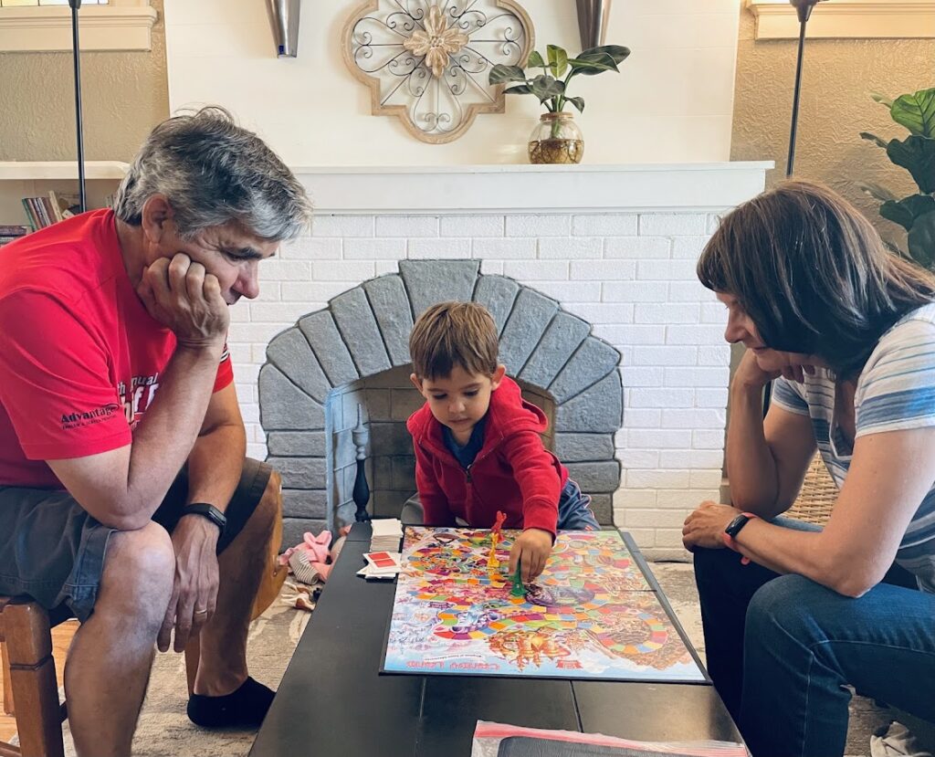 homeschool toddler playing candyland with grandparents