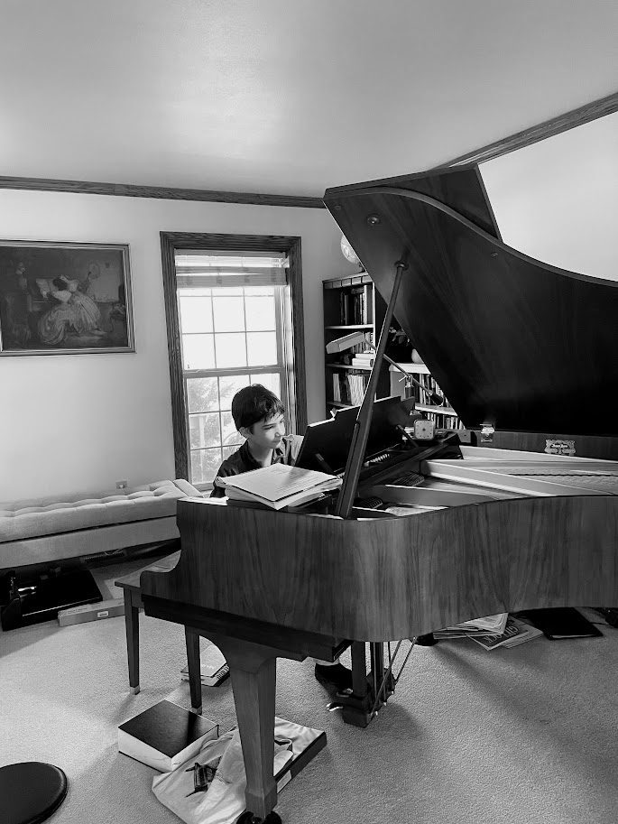 homeschool boy practicing piano on a grand piano