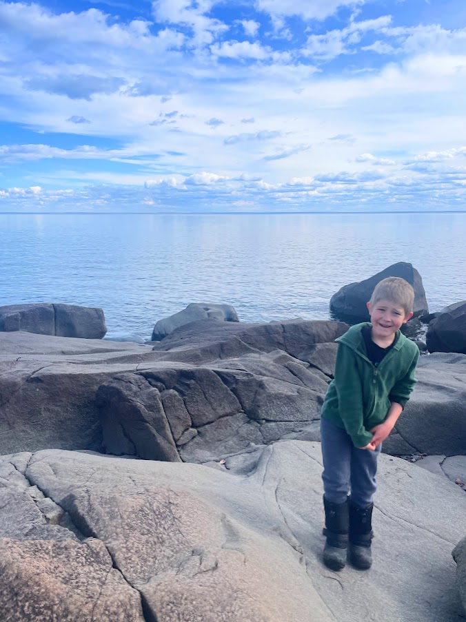 homeschool boy on a rock near Lake Superior