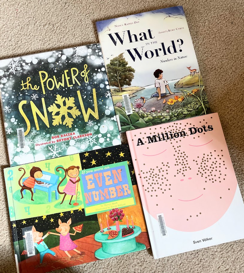 four math books for homeschooling lying on the floor