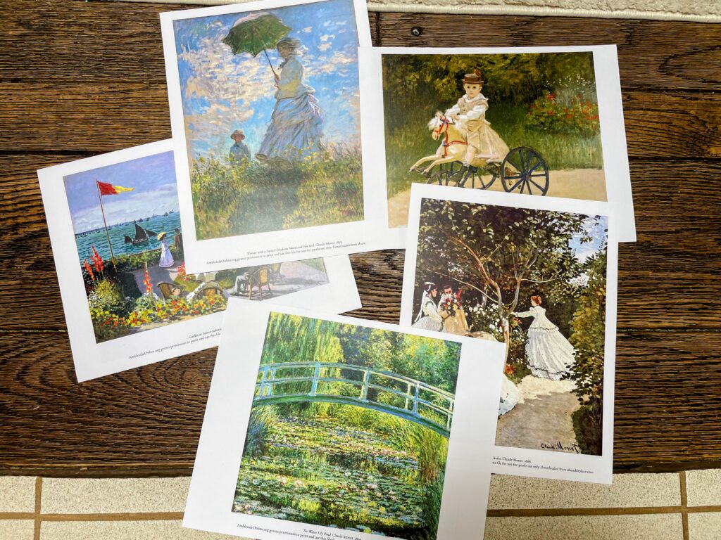 five prints of paintings by Monet on a wood floor